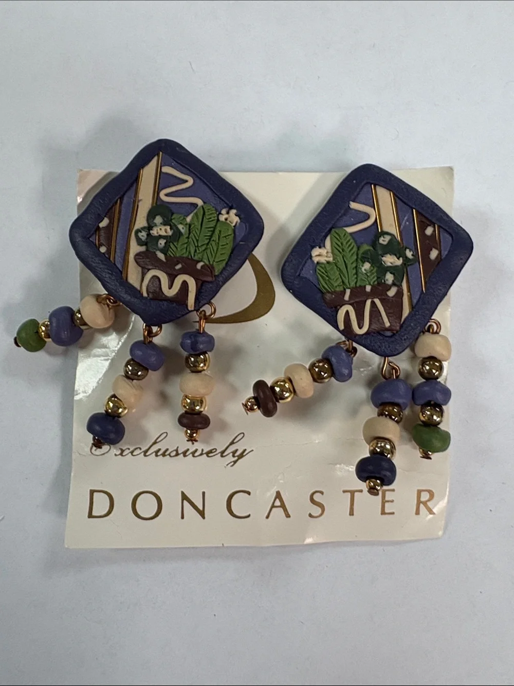 Doncaster Purple and Cream Beaded Drop clip on Earrings with Green Accents